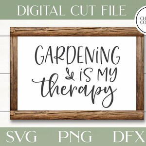 May include: A wooden sign with the text "Gardening is my therapy" in black script font. The sign is on a white wood background.