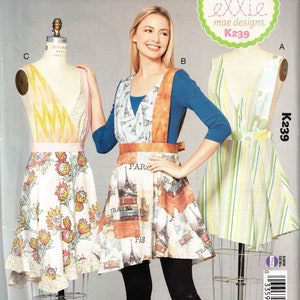 May include: Three asymmetrical apron sewing patterns. The pattern on the left has a floral print, the middle pattern has a Parisian theme, and the pattern on the right has a striped design. The pattern numbers are K239 and the title is "Asymmetrical Aprons".