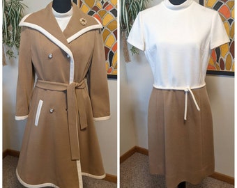 May include: Two vintage dresses, one a brown coat with white trim and a double-breasted closure, the other a white top with a brown skirt and a white tie.