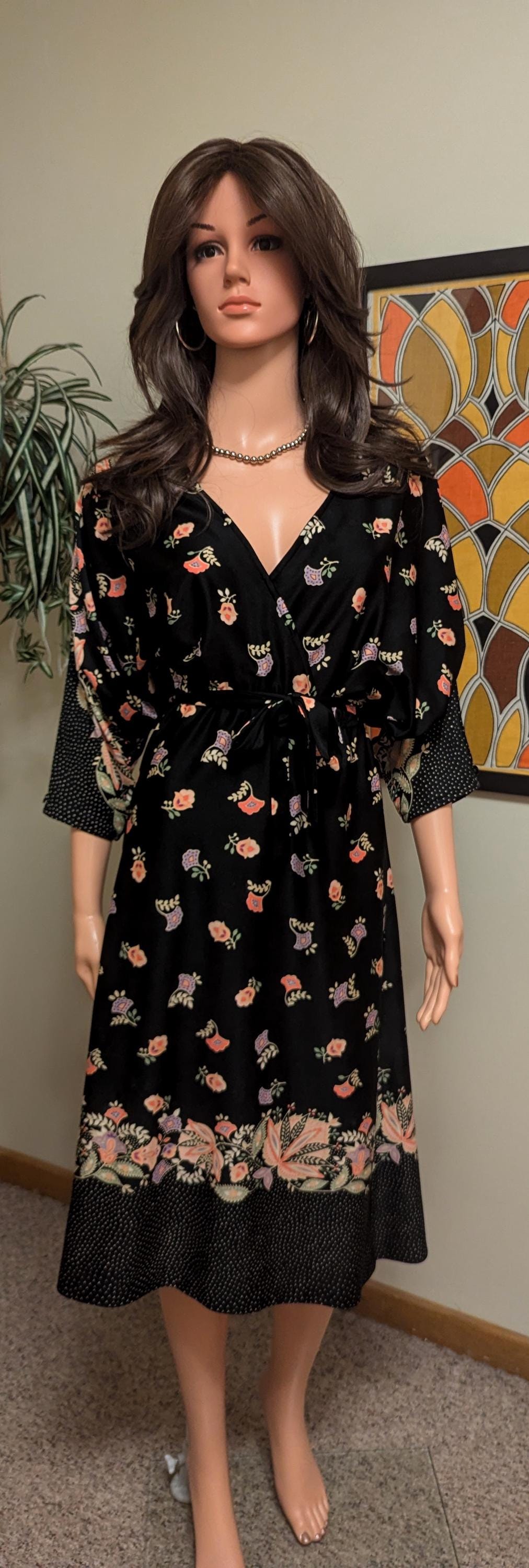 vintage 1970s black polyester wrap skirt with red and yellow floral rose print