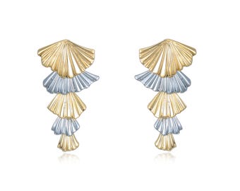 May include: A pair of dangling earrings with a layered fan design. Each earring alternates between gold and silver-colored metal, creating a cascading effect. The earrings are set against a white background.