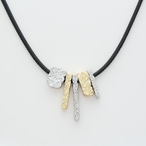 Eye-Catching Gold and Silver Pendants on Black Cord Necklace