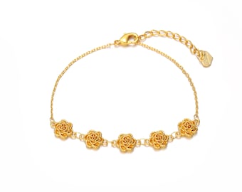 May include: A gold-colored bracelet featuring five detailed rose charms. The bracelet has a delicate chain and an adjustable clasp. The roses are evenly spaced along the chain, creating an elegant floral design.
