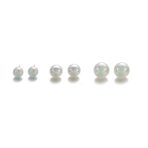 May include: Six lustrous, white pearls of varying sizes are arranged in a row against a white background. The pearls have a subtle iridescent sheen, reflecting soft colors. The image showcases the natural beauty of the pearls.