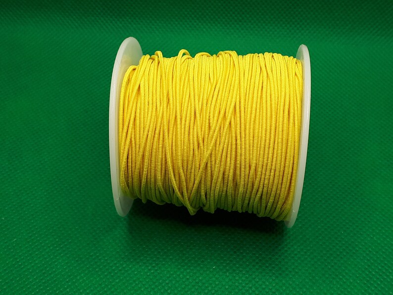 May include: A spool of bright yellow elastic cord.