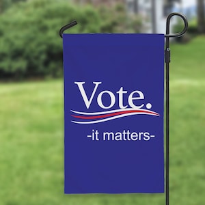 May include: Blue garden flag with white text that says "Vote." and "it matters" in smaller text below. The flag has a red, white, and blue wave design.