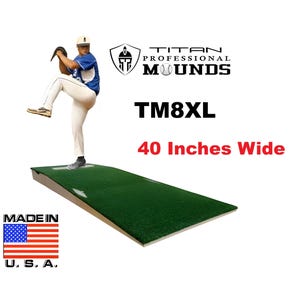 May include: A green baseball pitching mound with the text "TM8XL" and "40 Inches Wide". The image also includes the text "Titan Professional Mounds" and the American flag with "Made in U.S.A."