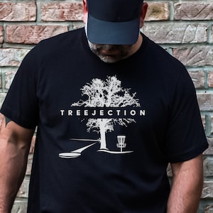 May include: Black t-shirt with a white graphic of a tree, a disc golf basket, and the text "TREEJECTION".