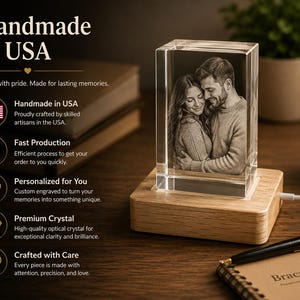 May include: A rectangular crystal block featuring a laser-engraved monochrome photograph of a couple embracing, mounted on a light-colored wooden base with a power cord. Text on the left includes 'Handmade in USA', 'Fast Production', 'Personalized for You', 'Premium Crystal', and 'Crafted with Care'.