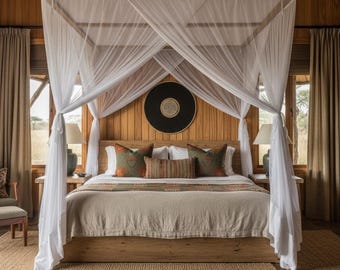 May include: A wooden canopy bed with white sheer curtains, a beige bedspread, and patterned throw pillows. The bed is positioned against a wood-paneled wall featuring a circular black and white wall hanging, flanked by two lamps on wooden nightstands.