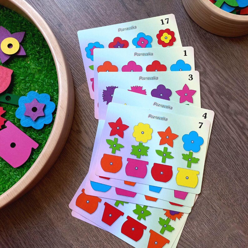 May include: A set of colorful flower matching cards with the word "Poznawaka" and numbers 1, 3, 4, 7, and 17. The cards feature different colored flowers and pots.