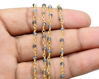 May include: A strand of gold chain with small, dark gray beads. The chain is approximately 18 inches long and is perfect for making jewelry.