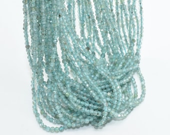 May include: A strand of light blue gemstone beads. The beads are faceted and have a slightly irregular shape. The strand is approximately 16 inches long.