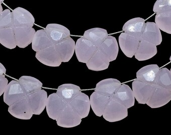 May include: A strand of pale pink gemstone beads, each bead is carved in the shape of a flower with four petals. The beads are strung on a silver wire.