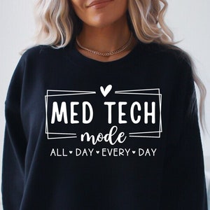 May include: Black sweatshirt with white text that reads "Med Tech mode All Day Every Day" with a heart symbol between each word.