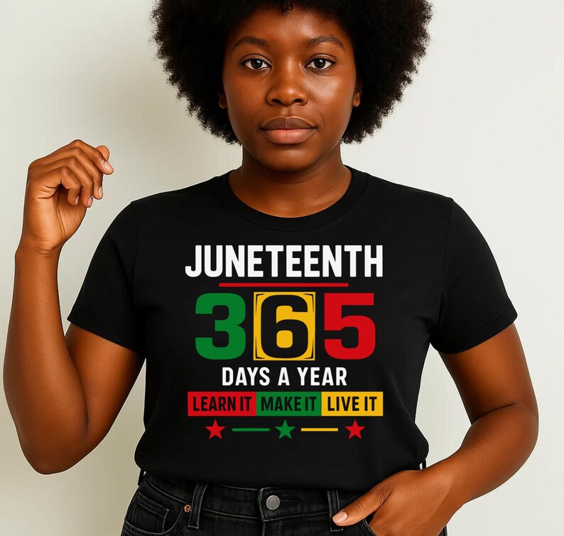 May include: Black t-shirt with the text "Juneteenth 365 Days a Year Learn It Make It Live It" in white and green, red, and yellow. There are three red stars below the text.