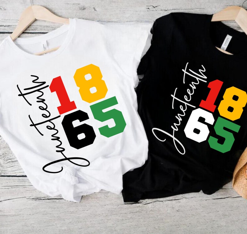 May include: Two t-shirts with the text "Juneteenth 1865" in black, red, yellow, and green. The text is in a block style font and the shirts are white and black.