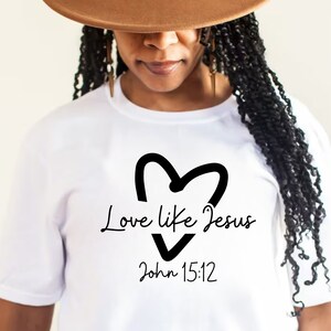 May include: White t-shirt with a black heart and the text "Love like Jesus John 15:12"