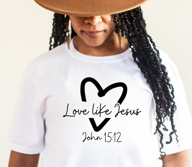 May include: White t-shirt with a black heart and the text "Love like Jesus John 15:12"
