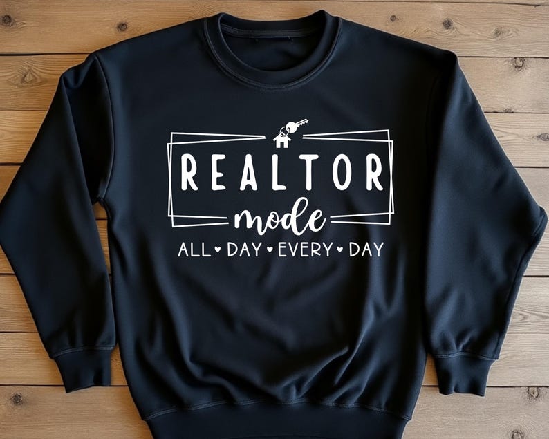 May include: Black sweatshirt with white text that reads "Realtor mode - All Day Every Day" with a house and key graphic.