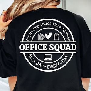 May include: Black sweatshirt with a white circle design that says "Organizing chaos since forever Office Squad All Day Every Day" with icons of a clock, heart, and filing cabinet.