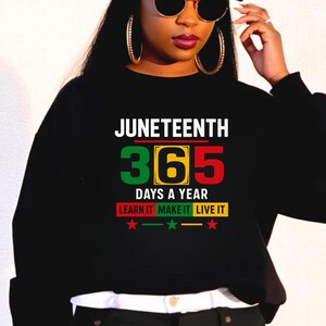 May include: Black sweatshirt with the text "Juneteenth 365 Days a Year Learn It Make It Live It" in green, yellow, and red lettering. There are three red stars below the text.