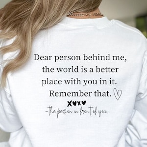 Può includere: Felpa bianca con il testo "Cara persona dietro di me, il mondo è un posto migliore con te. Ricordalo.  XOXO - La persona davanti a te."