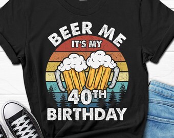 May include: Black t-shirt with a vintage-style graphic of two beer mugs and the text "Beer Me It's My 40th Birthday".