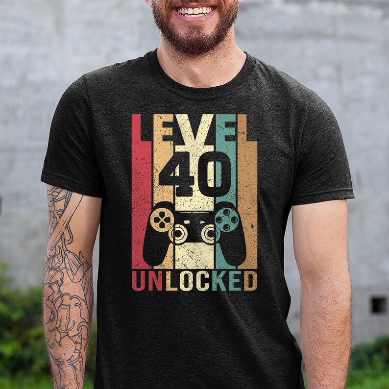 May include: A black t-shirt with a vintage-style graphic that says "Level 40 Unlocked" with a retro video game controller.