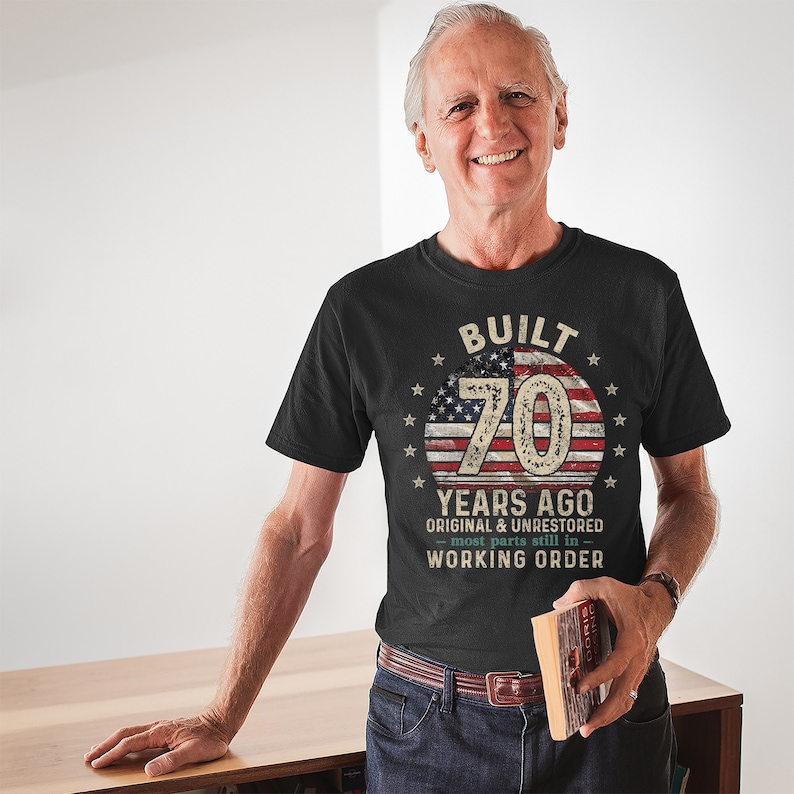 May include: Black t-shirt with a vintage American flag design and the text "Built 70 Years Ago Original & Unrestored - most parts still in - Working Order".