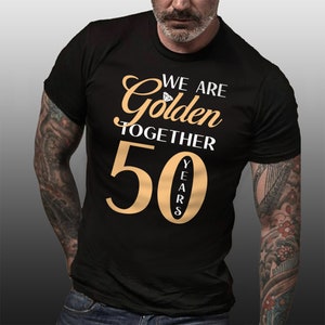 May include: Black t-shirt with the text "We are Golden Together 50 Years" in gold lettering. A diamond icon is above the word "Golden".