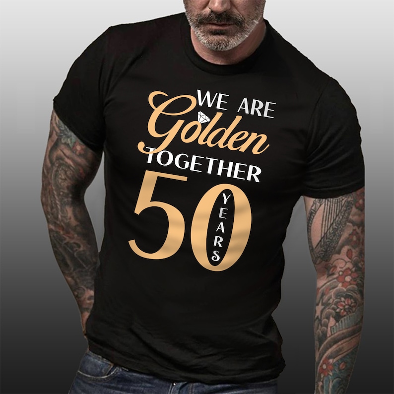 May include: Black t-shirt with the text "We are Golden Together 50 Years" in gold lettering. A diamond icon is above the word "Golden".