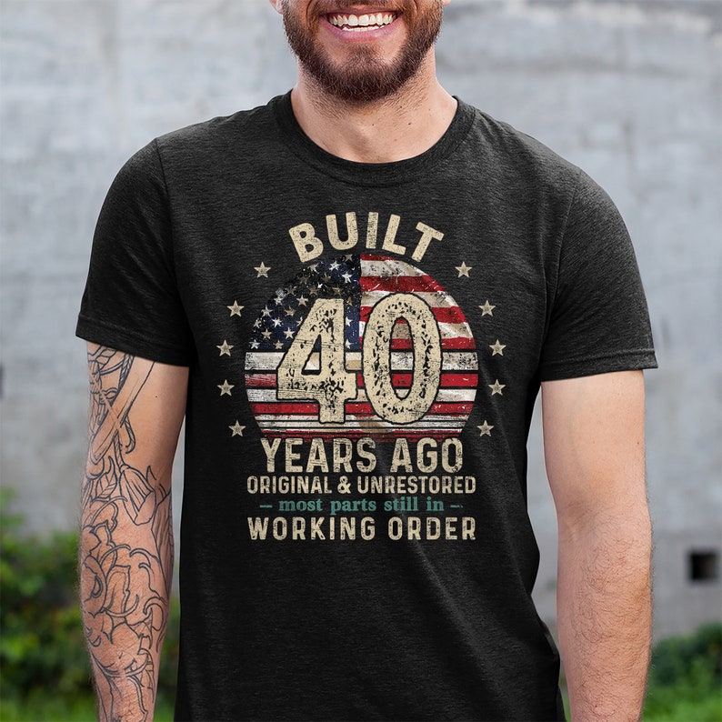 May include: A black t-shirt with a vintage American flag design and the text "Built 40 Years Ago Original & Unrestored - most parts still in - Working Order".