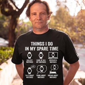 May include: Black t-shirt with the text "THINGS I DO IN MY SPARE TIME" and watch-themed graphics. The graphics include watches, a laptop, and thought bubbles with watch designs. The shirt's design lists activities like "Collect Watches" and "Dream About Watches."