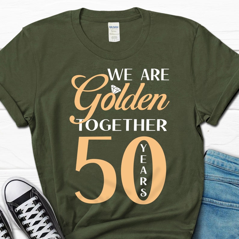 May include: A green t-shirt with the text "We are Golden Together 50 Years" in white and orange. The number 50 is large and the word "Years" is vertical.