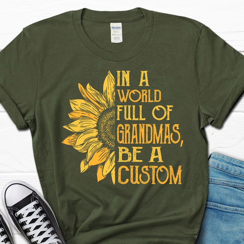 May include: A green t-shirt with a yellow sunflower graphic and the text "In a world full of grandmas, be a custom".