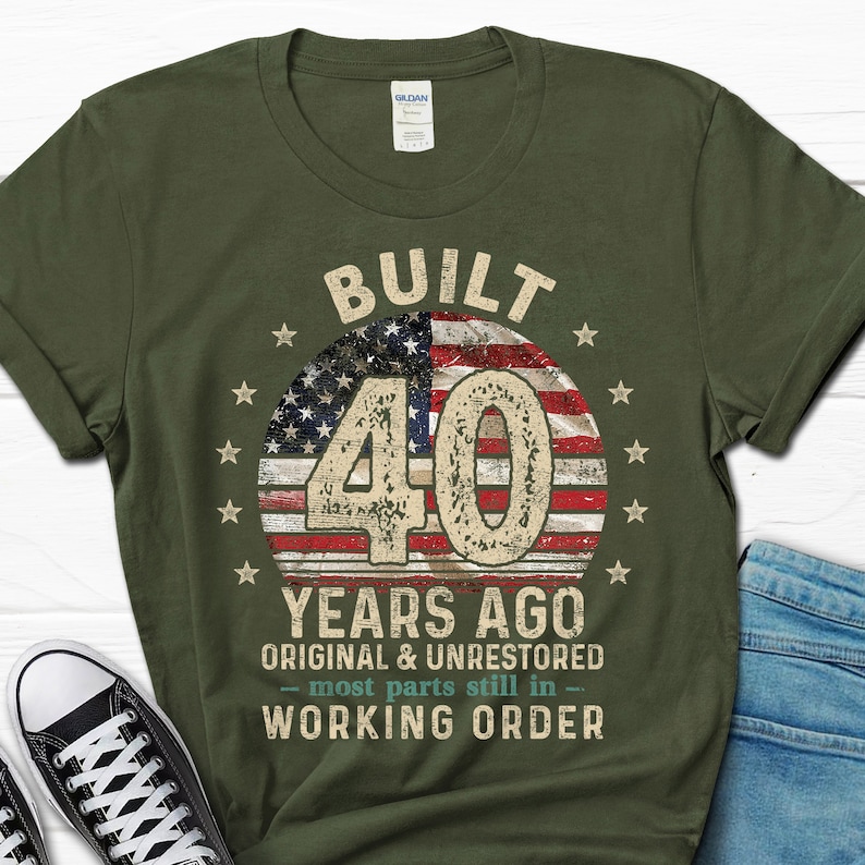 May include: Green t-shirt with a vintage American flag design and the text "BUILT 40 YEARS AGO ORIGINAL & UNRESTORED - most parts still in - WORKING ORDER".