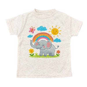 May include: A light gray t-shirt featuring a colorful crayon-style illustration of a smiling elephant under a rainbow, sun, and clouds. The design includes flowers and a butterfly, creating a cheerful, whimsical look.