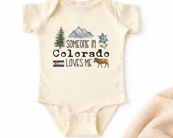 Babybody aus Baumwolle in Naturfarbe mit Aufdruck „Jemand in Colorado liebt mich“ – Babyoutfit aus den Bergstaaten, Geschenkidee für Babys aus Colorado, Kinder-Shirt aus Colorado