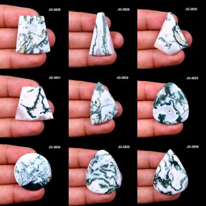 May include: Nine polished gemstones with unique shapes and patterns. The stones feature a white base with green and black veining, creating a natural, organic appearance. Each stone is held in a hand, showcasing the variety of shapes and sizes.