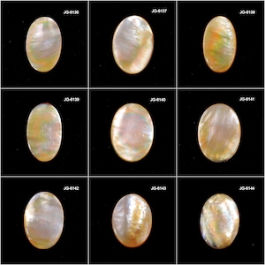 May include: Nine oval-shaped mother-of-pearl cabochons with iridescent surfaces. Each gemstone displays a unique blend of colors, including white, gold, and hints of green and pink. The gemstones are set against a black background.