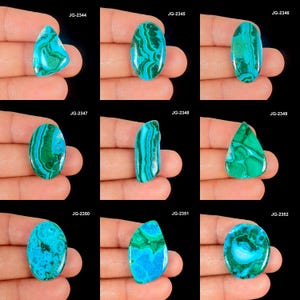 May include: Nine polished gemstones in various shapes, held in a hand. The stones display a mix of teal and green colors with unique patterns. Each stone has a different shape, including oval, teardrop, and irregular forms. The image is set against a black background.