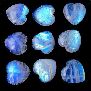 May include: Nine heart-shaped moonstone crystals with iridescent blue and white colours. The crystals are polished and have a smooth, glossy finish.