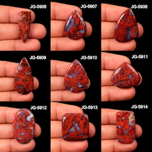 May include: Nine polished gemstones with unique shapes and patterns. The stones feature a mix of red, white, and blue hues, with intricate veining and textures. Each stone is held in a hand against a black background, showcasing the natural beauty of the minerals.