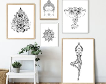 May include: Five black and white framed prints on a white wall. The prints feature a mandala, a Buddha head, a yoga pose, an elephant, and a floral design with an eye in the center.
