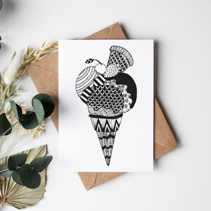 May include: A black and white illustration of an ice cream cone with three scoops of ice cream. The ice cream is decorated with intricate patterns.