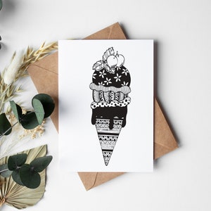 May include: Black and white illustration of an ice cream cone with two scoops of ice cream, a cherry on top, and a decorative pattern.