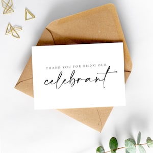 May include: A white card with black text that reads "Thank you for being our celebrant". The card is sitting on a brown envelope.