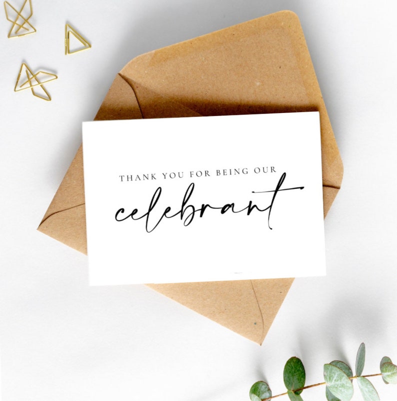 May include: A white card with black text that reads "Thank you for being our celebrant". The card is sitting on a brown envelope.