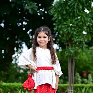 Girls ready to wear embellished Kaftan top comes with a straight pant.